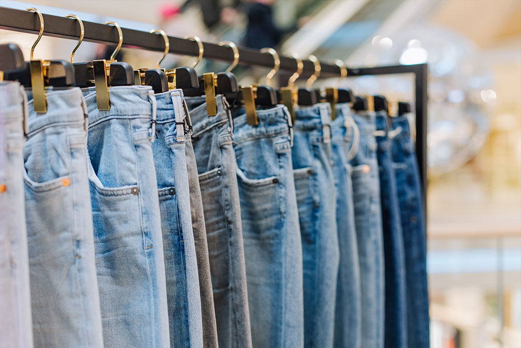 Premium denim jeans hanging in a textile export showroom – Dharmshil Group