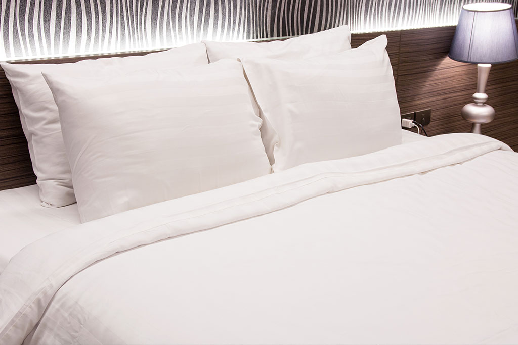 White bedsheet textile material prepared for home furnishing exports