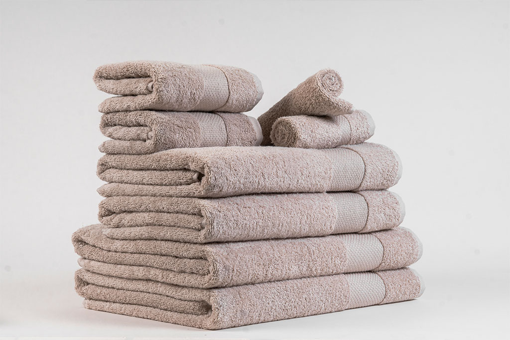 Soft, export-grade cotton towels neatly folded for global distribution